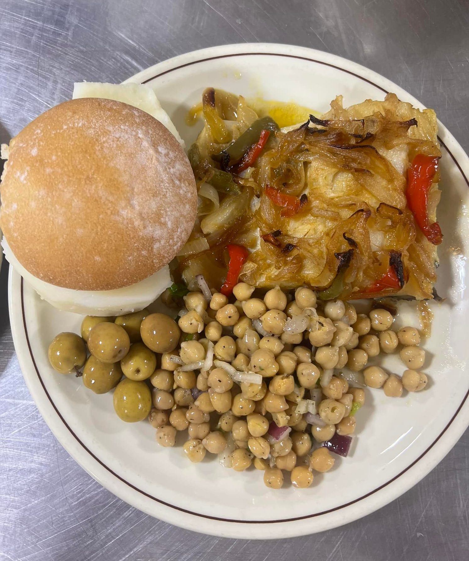 photo showing fresh cod with a side of chickpea salad and fresh bun cooked by the Luso Ladies in Kitimat